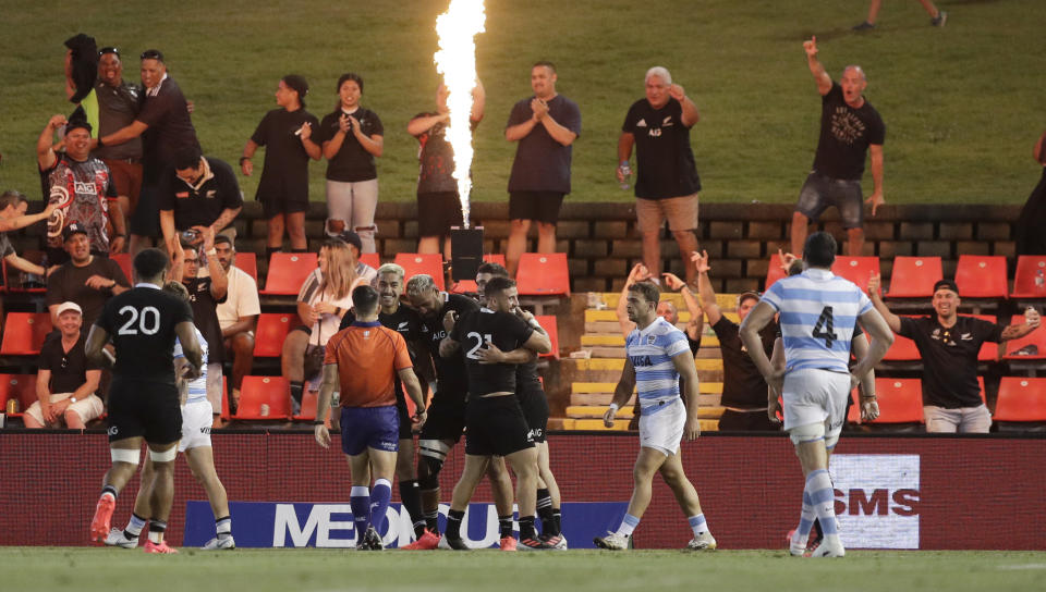 New Zealand's Patrick Tuipulotu is congratulated by teammates after scoring his team's fifth try during the Tri-Nations rugby test between Argentina and the All Blacks in Newcastle, Australia, Saturday, Nov. 28, 2020. (AP Photo/Rick Rycroft)