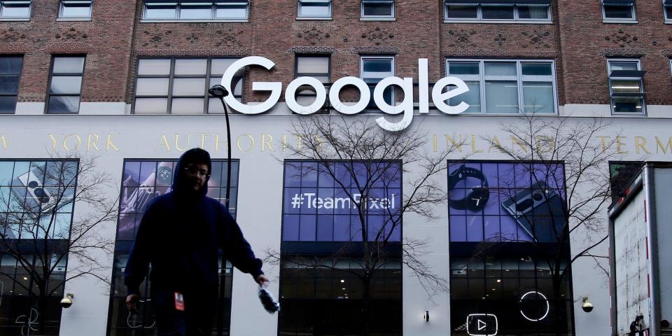 A person walking in front of a Google office building.