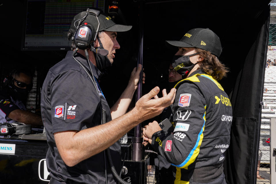 Colton Herta, right, talks with his father Bryan Herta during practice for the Indianapolis 500 auto race at Indianapolis Motor Speedway in Indianapolis, Friday, May 21, 2021. (AP Photo/Michael Conroy)