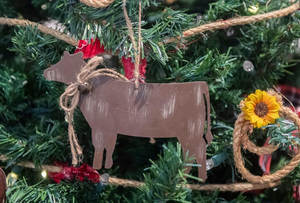 A bovine ornament adorns the San Joaquin Stanislaus CattleWomen's Christmas tree at the annual Festival of Trees at the San Joaquin County Historical Museum at Micke Grove in Lodi on Tuesday, Nov. 29, 2022. The festival, which will feature more than 60 decorated trees, will run from 1 p.m. to 4 p.m. for seniors only on Friday, Dec 2. On Saturday, Dec. 3 and Sunday Dec. 4, it will be open to the public from 10 a.m to 4 p.m.