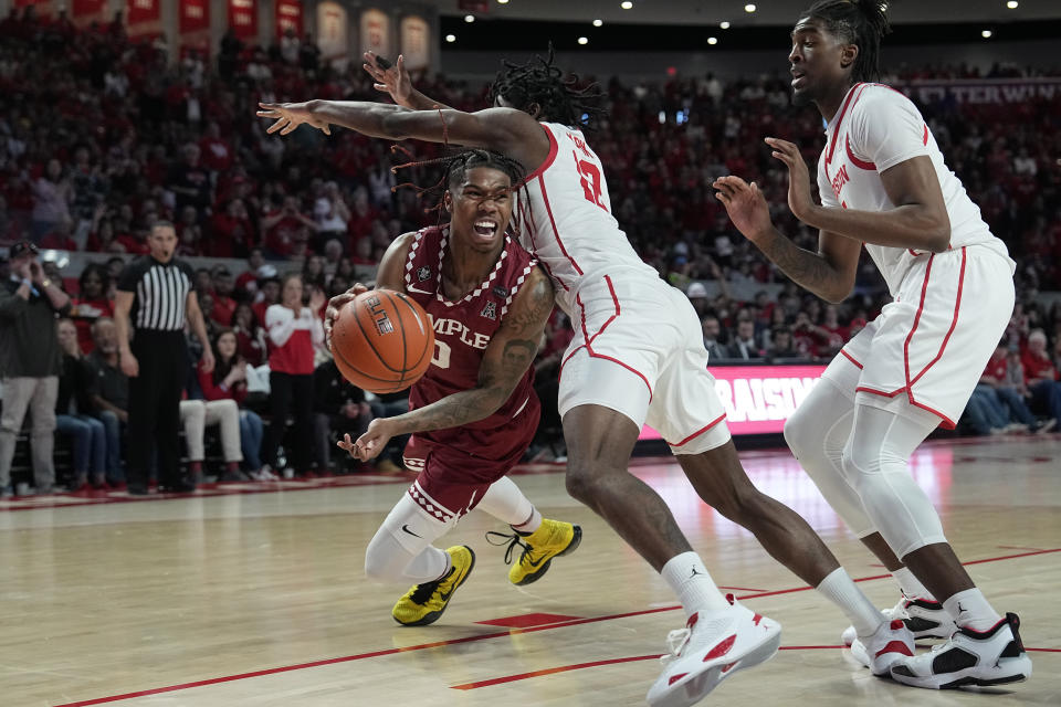 Temple's Khalif Battle (0) pass the ball around Houston's Tramon Mark (12) during the second half of an NCAA college basketball game Sunday, Jan. 22, 2023, in Houston. Temple won 56-55. (AP Photo/David J. Phillip)