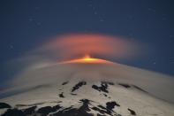 Smoke and lava spew from the Villarrica volcano, as seen from Pucon town in the south of Santiago, March 3, 2015. The volcano went quiet on Tuesday after an eruption that sent a plume of ash and lava high into the sky in the early hours put Chile on high alert. (REUTERS/Claudia Bucarey)