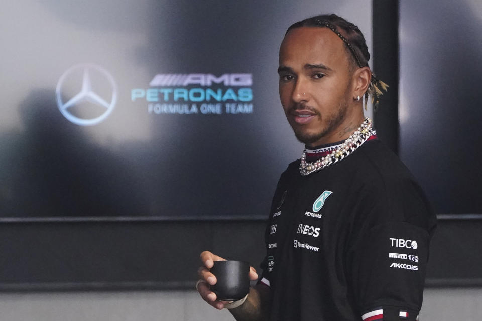 Mercedes driver Lewis Hamilton of Britain arrives for the first practice session for the Formula One Miami Grand Prix auto race wearing various items of jewelry at the Miami International Autodrome, Friday, May 6, 2022, in Miami Gardens, Fla. (AP Photo/Wilfredo Lee)