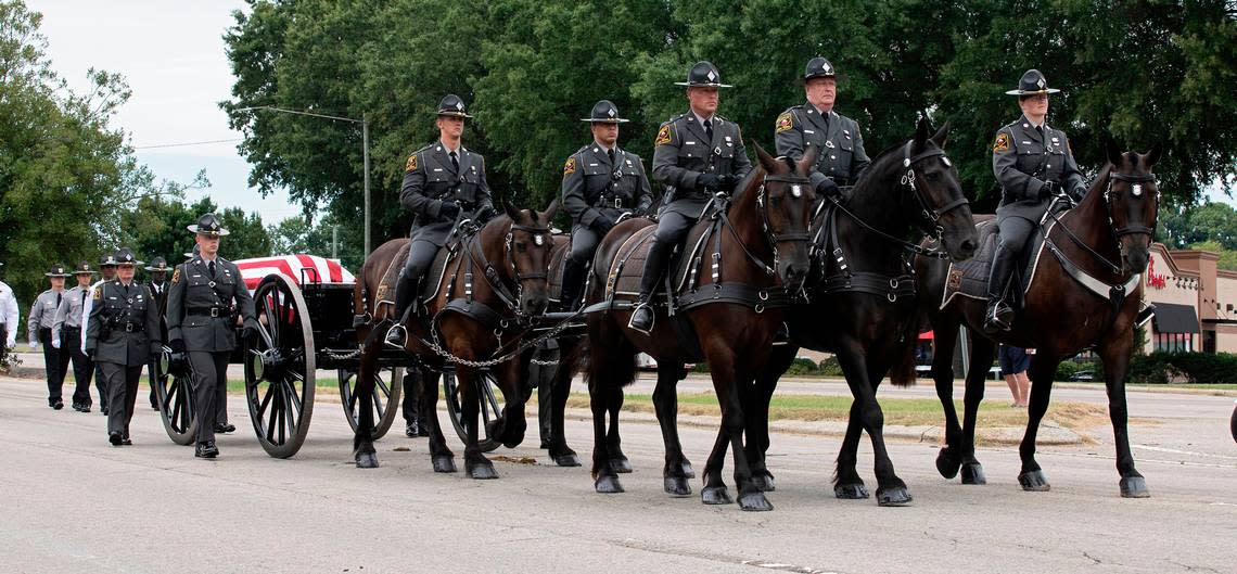 The N.C. State Highway Patrolís Caisson Unit carries the casket of slain Wake County Sheriffís Deputy Ned Byrd down Glenwood Avenue on Friday, Aug. 19, 2022, in Raleigh, N.C. Byrd was found dead with multiple gunshot wounds early Friday morning, Aug. 12 in southeastern Wake County.