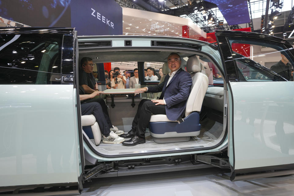 Visitors sit inside a Zeekr Mix car during the China Auto Show in Beijing, China, Friday, April 26, 2024. China's vision of the future of the automobile electrified and digitally connected is on display at the ongoing Beijing auto show. (AP Photo/Tatan Syuflana)