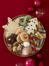 <p>Nowadays <a href="https://www.countryliving.com/food-drinks/g647/holiday-cookies-1208/" rel="nofollow noopener" target="_blank" data-ylk="slk:Christmas cookies;elm:context_link;itc:0;sec:content-canvas" class="link ">Christmas cookies</a> come in all manner of festive flavors and shapes, but their origin stems from Medieval Europe when ingredients like nutmeg, cinnamon, ginger, and dried fruit were beginning to appear in recipes for special biscuits baked during Christmastime. While early Christmas cookie recipes in the U.S. made their debut in the late 18th century, the modern Christmas cookie didn't emerge until the turn of the 19th century when a change to import laws allowed inexpensive kitchen items like cookie cutters to arrive from Europe according to William Woys Weaver, author of <a href="https://www.amazon.com/Christmas-Cook-Centuries-American-Yuletide/dp/0060965525?tag=syn-yahoo-20&ascsubtag=%5Bartid%7C10050.g.33822089%5Bsrc%7Cyahoo-us" rel="nofollow noopener" target="_blank" data-ylk="slk:The Christmas Cook: Three Centuries of American Yuletide Sweets;elm:context_link;itc:0;sec:content-canvas" class="link "><em>The Christmas Cook: Three Centuries of American Yuletide Sweets</em></a>. These cutters often depicted ornate, secular shapes, like Christmas trees and stars, and as new recipes to go along with them began to be published, the modern tradition of cooking baking and exchanging was born. </p>