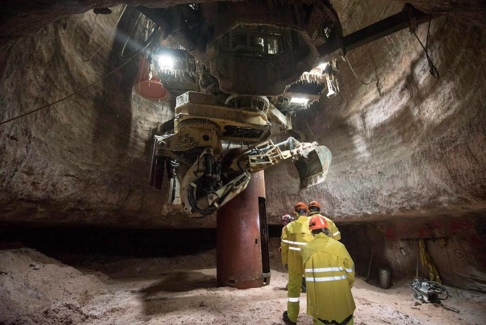 Members of the media make their way to the elevator underground at a potash mine.