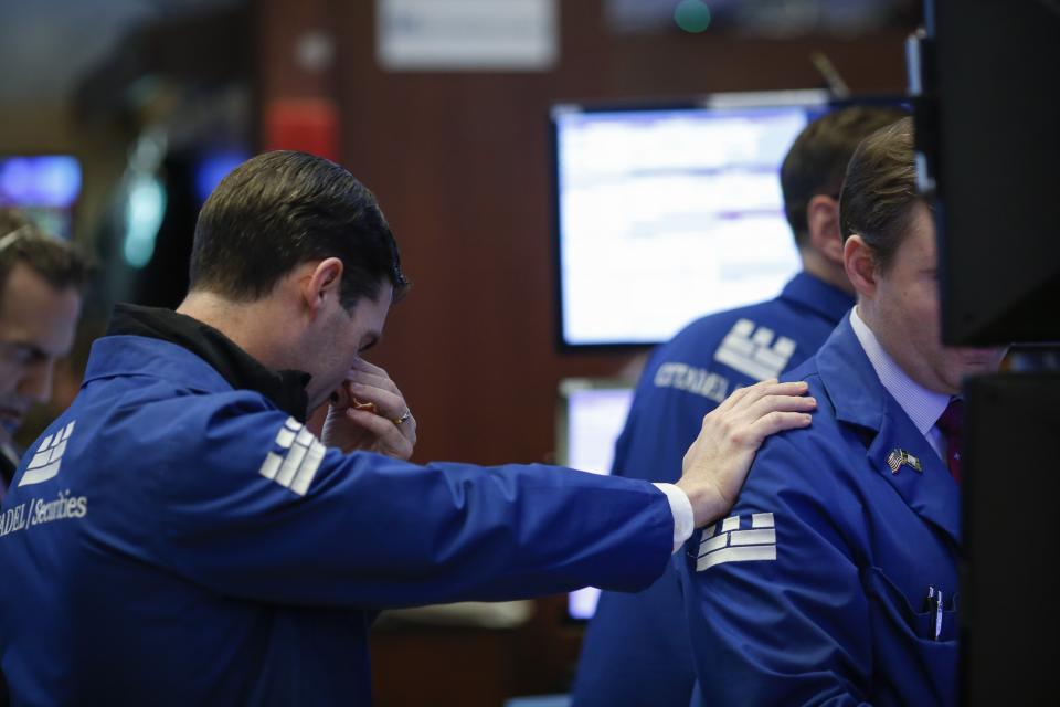 Traders and financial professionals work on the floor of the New York Stock Exchange (NYSE) ahead of the closing bell, March 22, 2018 in New York City. (Photo by Drew Angerer/Getty Images)