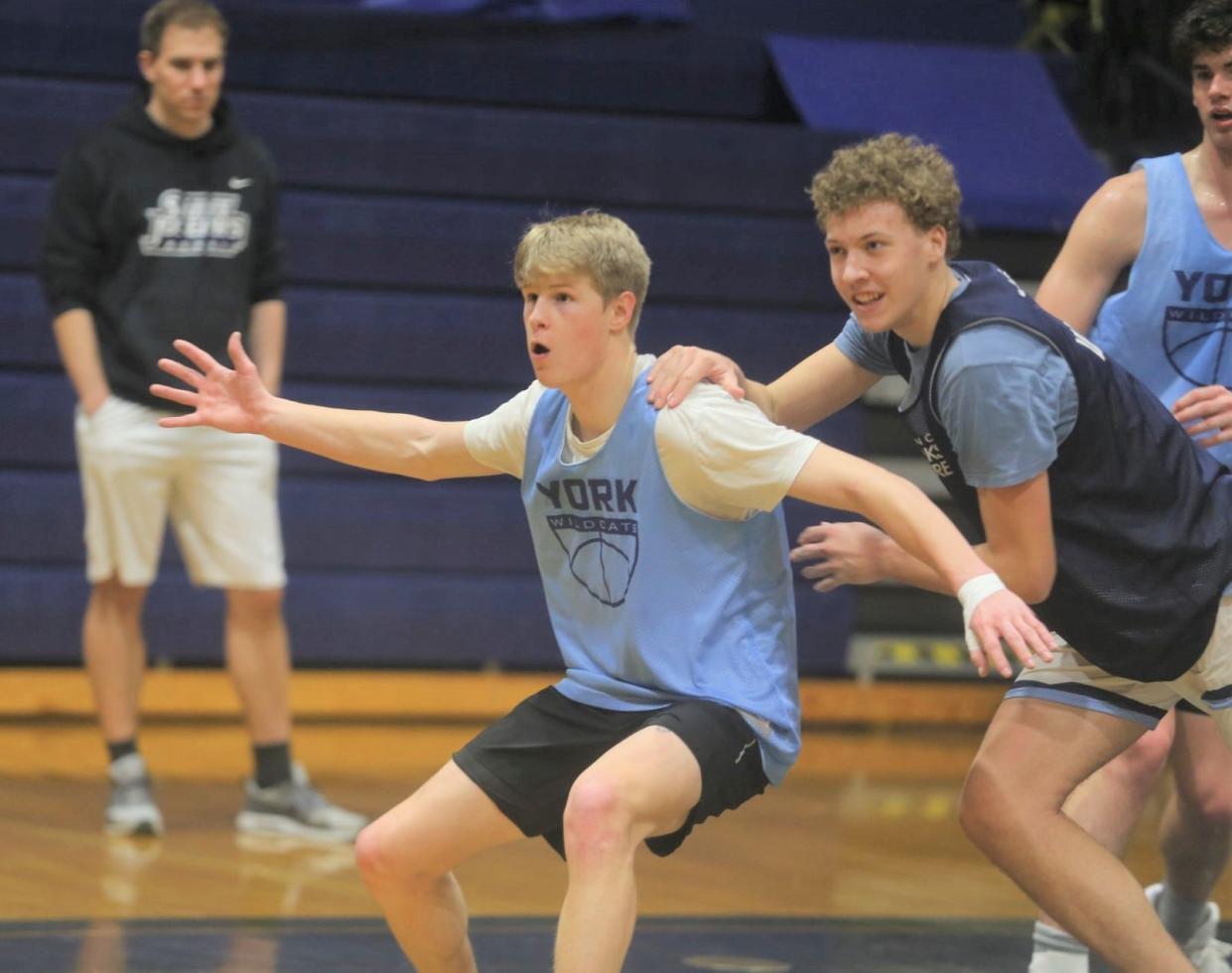 York's Haydn Forbes posts up teammate Lucas Ketchum during Monday's boys basketball practice. Forbes is expected to be back in game action later in the season as he deals with an injured left thumb.