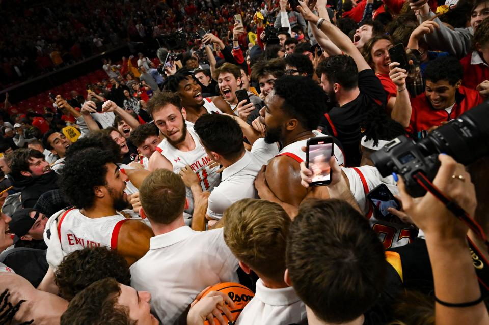 The Maryland Terrapins celebrate with fans after their win over Purdue.