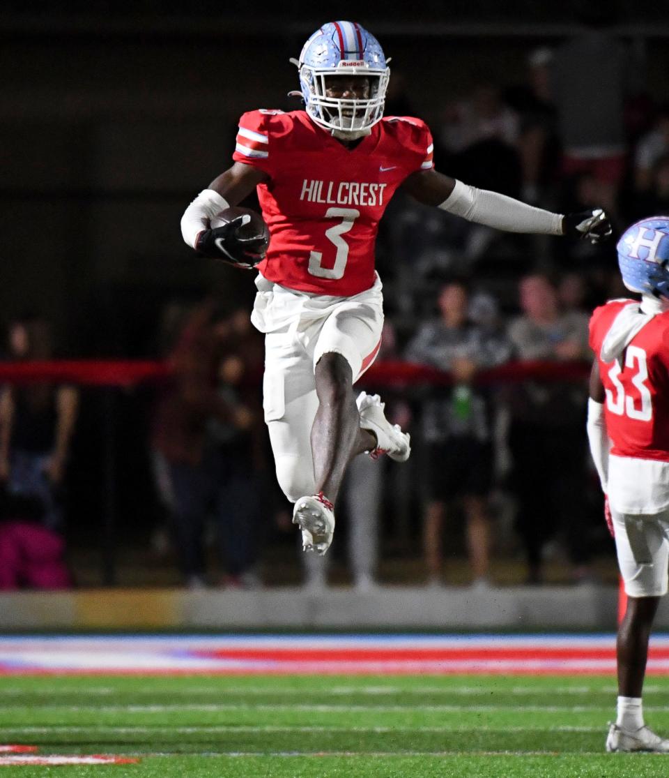 Hillcrest defensive back TJ Banks (3) leaps as he runs the ball on a fake punt which was canceled by a penalty as Hillcrest defeated Helena to advance to the third round of the AHSAA playoffs Friday, Nov. 17, 2023.