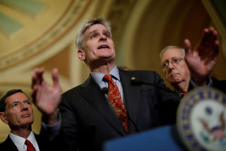FILE PHOTO: Sen. Bill Cassidy (R-LA), accompanied by Sen. John Barrasso (R-WY) and Senate Majority Leader Mitch McConnell, speaks with reporters about the Cassidy-Graham healthcare bill following the party luncheons on Capitol Hill in Washington, U.S., September 19, 2017. REUTERS/Aaron P. Bernstein/File Photo