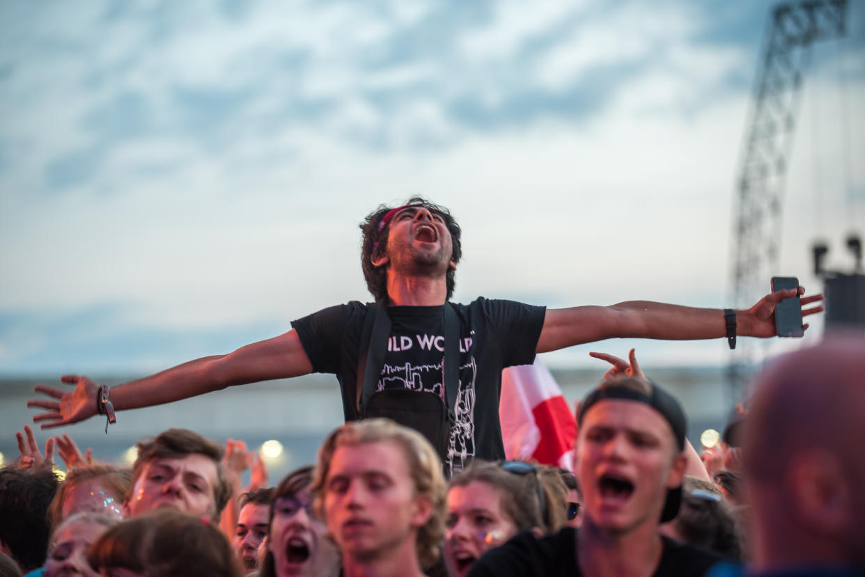 People waving flags and holding flares, and general atmosphere of the Reading Festival 2017 are pictured at Reading, on August 27, 2017. The Reading and Leeds Festivals are a pair of annual rock music festivals that take place in Reading and Leeds in England. The events take place simultaneously on the Friday, Saturday and Sunday of the August bank holiday weekend, sharing the same bill. (Photo by Alberto Pezzali/NurPhoto via Getty Images)