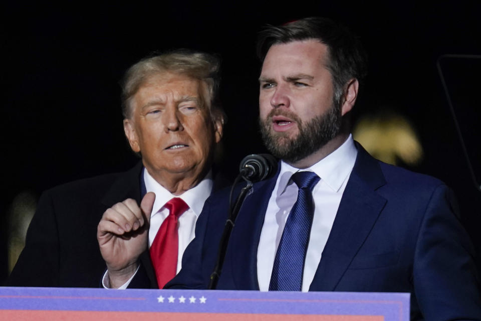 Ohio Senate candidate JD Vance speaks as former President Donald Trump listens at a campaign rally at Wright Bros. Aero Inc. at Dayton International Airport on Monday, Nov. 7, 2022, in Vandalia, Ohio. (AP Photo/Michael Conroy)