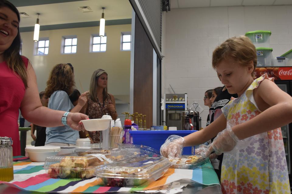 Student Charlotte Kelley served pastries to teachers at Maverick Cafe at Mill Creek Middle School's concession stand on Friday, May 20, 2022 in Nolensville, Tenn.