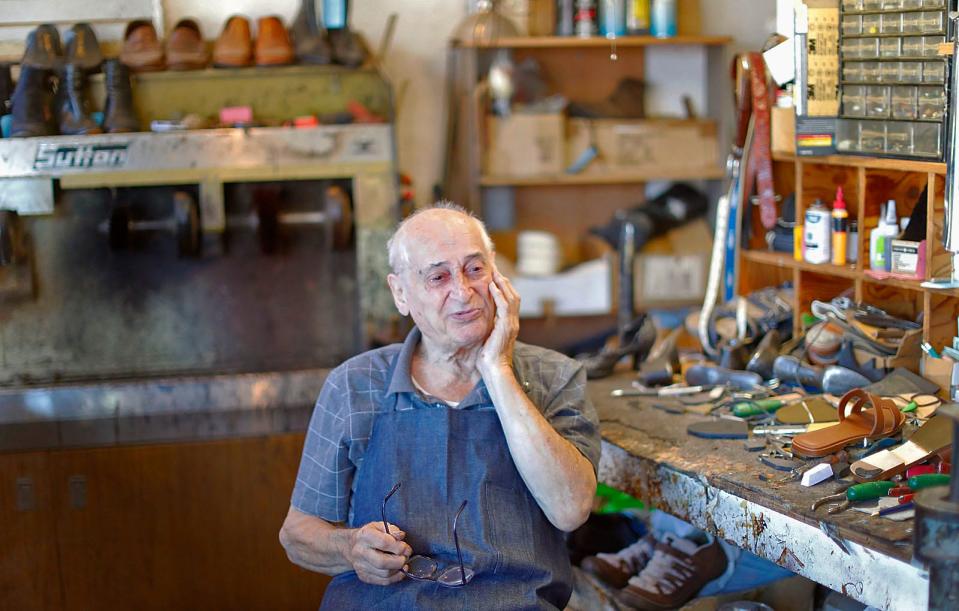 Vincenzo DiRado, 91, wipes away a tear after saying goodbye to one of his longtime customers.