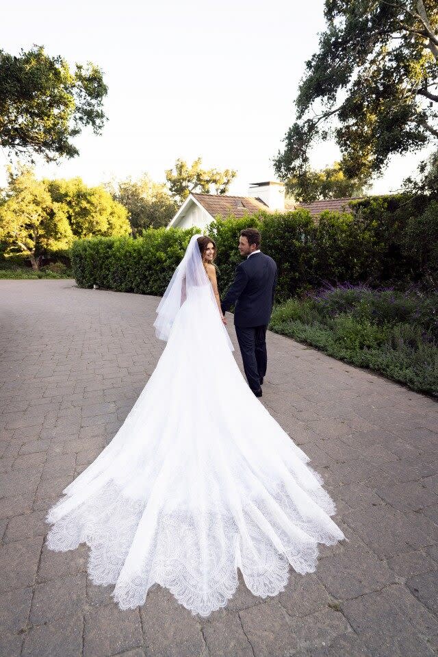 Get the scoop on the bride's wedding gown and reception dress, custom designed by Giorgio Armani.