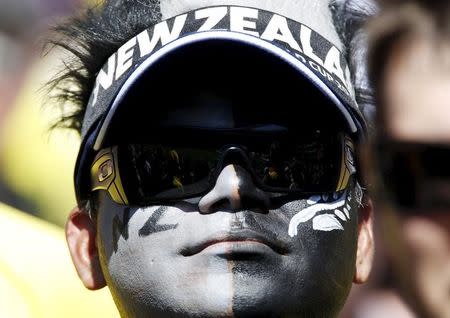 A New Zealand supporter with his face painted listens to the playing of the national anthems before the start of the Cricket World Cup final match between Australia and New Zealand at the Melbourne Cricket Ground (MCG) March 29, 2015. REUTERS/Brandon Malone