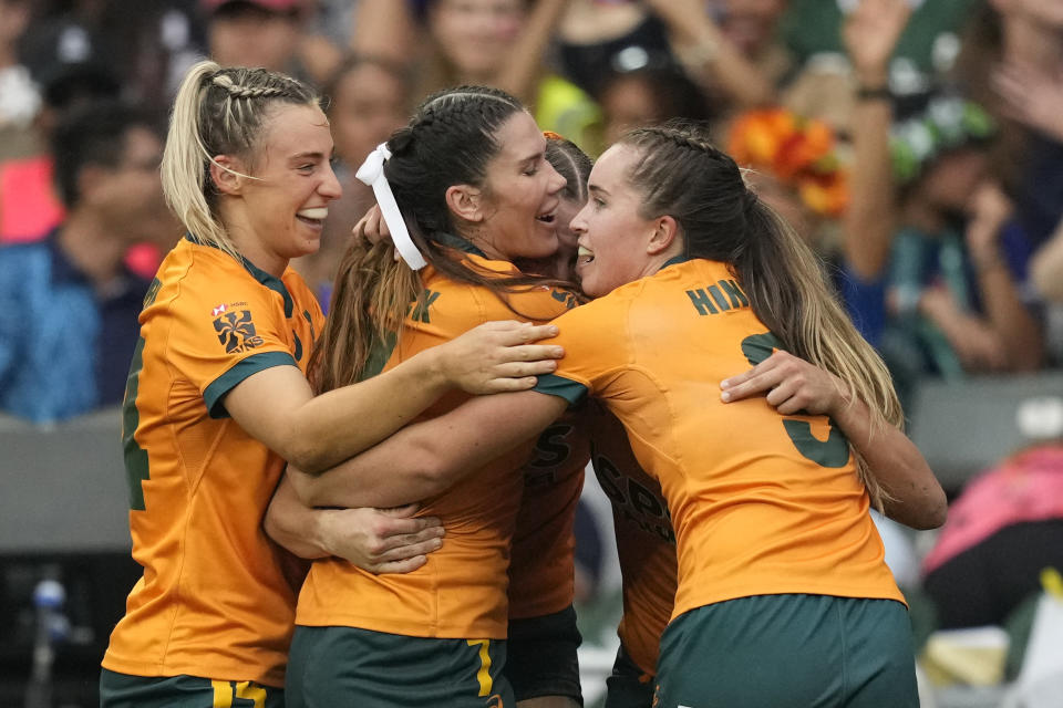 Australian players celebrate after winning the third place match against France during the women's third place match in the Hong Kong Sevens rugby tournament in Hong Kong, Sunday, April 7, 2024. (AP Photo/Louise Delmotte)