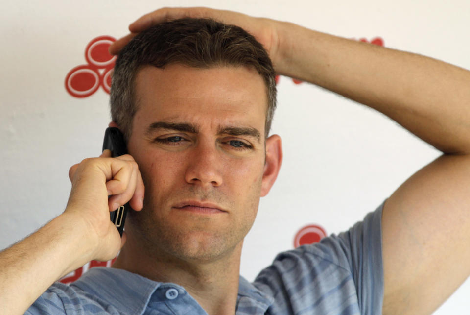 FILE - In this June 15, 2012 file photo, Chicago Cubs President Theo Epstein talks on his phone before an interleague baseball game against the Boston Red Sox in Chicago. Kathleen Kearney, 44, of Canton, Mass., appeared in a Cook County courtroom, Tuesday, July 17, in Chicago, where she was charged with two felony counts of stalking Epstein after she was arrested on Monday trying to deliver a birthday present to his young son at his Chicago home. Prosecutors say Kearney had tried to contact Epstein several times when he was the general manager of the Red Sox. (AP Photo/Nam Y. Huh, File)