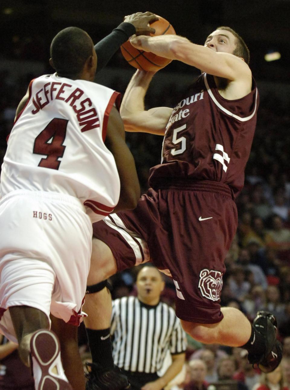 Arkansas' Dontell Jefferson (4) blocks a shot by Missouri State's Blake Ahearn, right, in the second half of an NCAA basketball game in Fayetteville, Ark., Thursday, Dec. 15, 2005. Ahearn scored a team-high 16 points in a losing effort as Arkansas won, 79-75.
