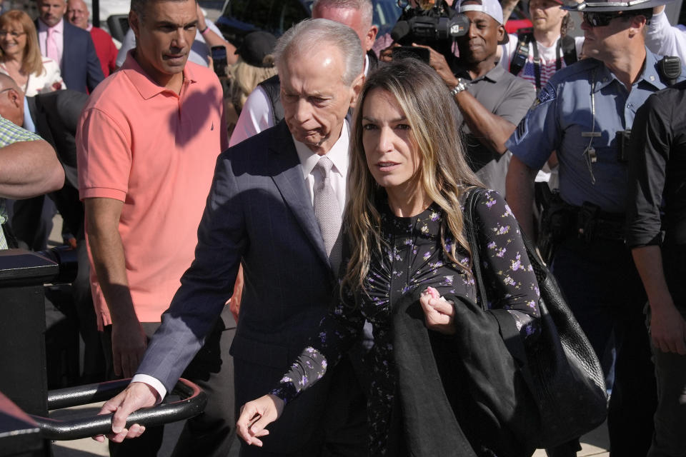 Karen Read arrives at Norfolk Superior Court with her father William Read, center left, Tuesday, June 25, 2024, in Dedham, Mass. Karen Read is on trial, accused of killing her boyfriend Boston police Officer John O'Keefe, in 2022. (AP Photo/Steven Senne)