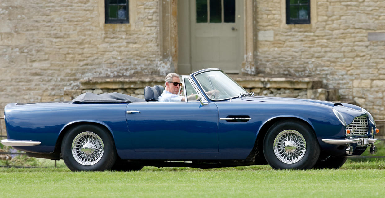 CRIENCESTER, UNITED KINGDOM - JUNE 17: (EMBARGOED FOR PUBLICATION IN UK NEWSPAPERS UNTIL 24 HOURS AFTER CREATE DATE AND TIME) Prince Charles, Prince of Wales accompanied by Camilla, Duchess of Cornwall arrives, driving his 1969 Aston Martin DB6 Volante, to play in the Burberry Cup polo match at Cirencester Park Polo Club on June 17, 2005 in Cirencester, England. (Photo by Max Mumby/Indigo/Getty Images)