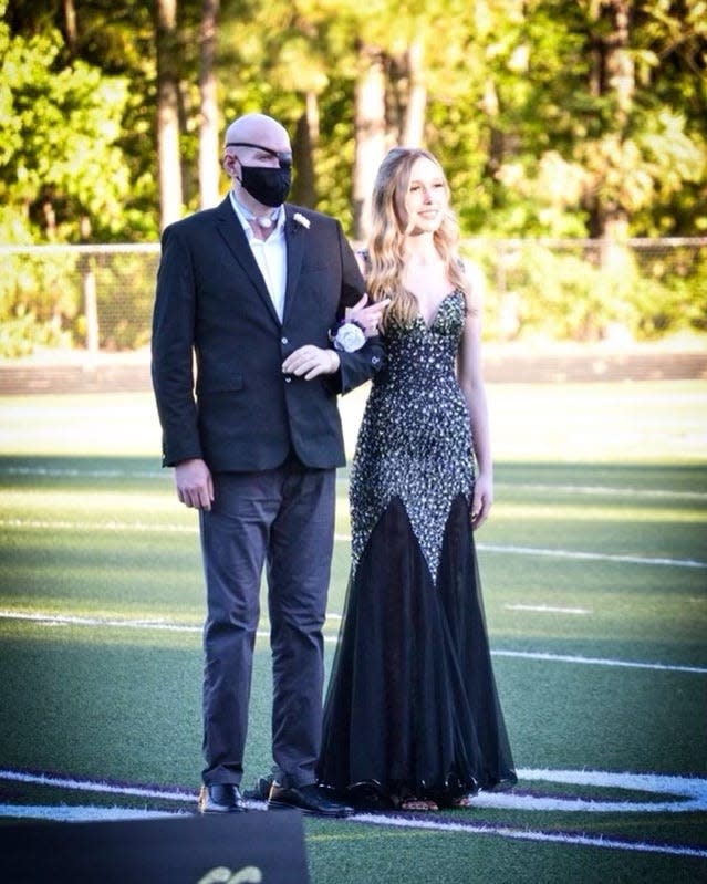 Aaron James walks with his daughter Allie during her 2019 high school homecoming.