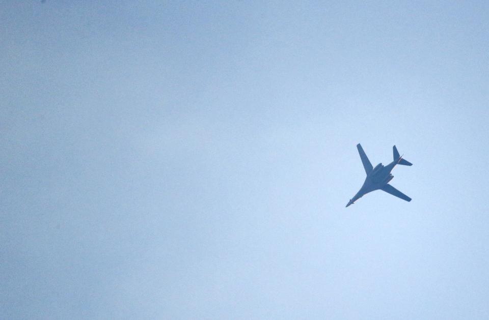 A U.S.-led coalition aircraft flying over Kobanii, as seen near the Mursitpinar border crossing on the Turkish-Syrian border in the southeastern town of Suruc in Sanliurfa province, October 18, 2014. A U.S.-led military coalition has been bombing Islamic State fighters who hold a large swathe of territory in both Iraq and Syria, two countries involved in complex multi-sided civil wars in which nearly every country in the Middle East has a stake.. REUTERS/Kai Pfaffenbach (TURKEY - Tags: MILITARY POLITICS CONFLICT)