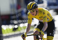 Slovenia's Tadej Pogacar, wearing the overall leader's yellow jersey, strains during the twenty-first and last stage of the Tour de France cycling race over 108.4 kilometers (67.4 miles) with start in Chatou and finish on the Champs Elysees in Paris, France,Sunday, July 18, 2021. (AP Photo/Christophe Ena)