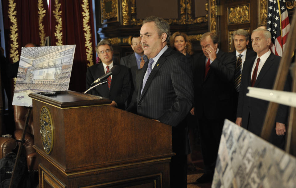 Minnesota Gov. Mark Dayton, right, listens as Minnesota Vikings NFL football owner Zygi Wilf addresses a news conference Thursday, March 1, 2012 in St. Paul , Minn., where it was announced that a site for a new Vikings football stadium along with a financing agreement had been reached. (AP Photo/Jim Mone)