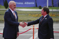 Albania's Prime Minister Edi Rama, left, welcomes European Commissioner for Neighbourhood and Enlargement Oliver Varhelyi before a summit in Tirana, Albania, Thursday, Feb. 29, 2024. The leaders of Western Balkan countries met Thursday in another joint push to use the European Union's financial support plan of six billion euros (about $6.5 billion) hoping it will speed up its membership in the bloc. (AP Photo/Armando Babani)