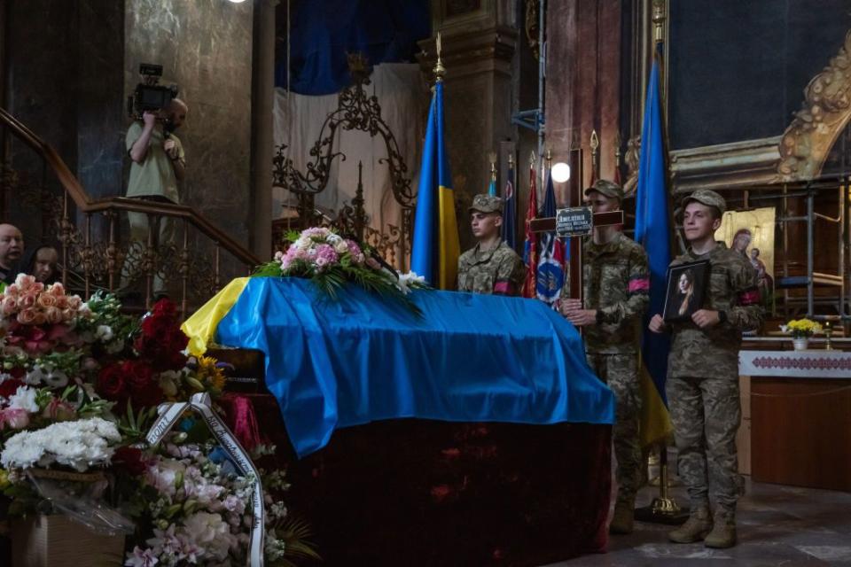 The coffin of Victoria Amelina, a renowned Ukrainian writer, draped in the Ukrainian flag, at her funeral ceremony in Lviv, Ukraine, on July 5, 2023. She died on July 1, 2023, after she was critically injured in a Russian missile strike on Kramatorsk, Donetsk Oblast. (Photo by Olena Znak/Anadolu Agency via Getty Images)