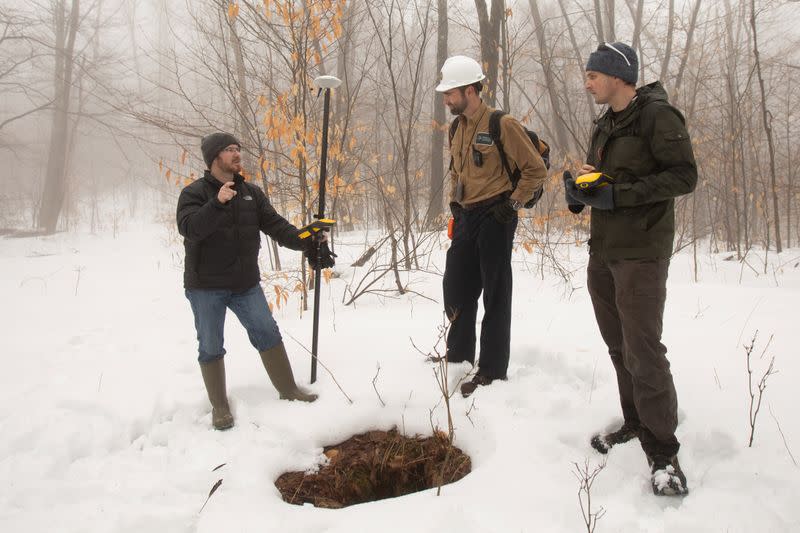 Timothy De Smet, Nathan Graber and Alex Nikulin use a global navigation satellite system and geodetic antenna to locate an abandoned oil well in Olean, New York