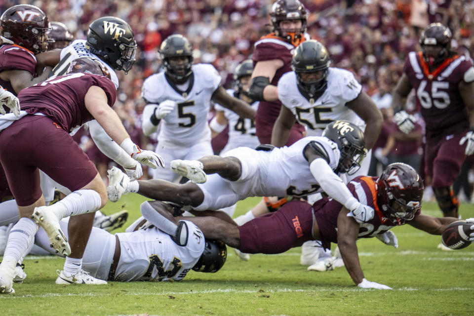 Virginia Tech's Bhayshul Tuten (25) stretches for the touchdown against Wake Forest during the first half of an NCAA college football game, Saturday, Oct. 14, 2023, in Blacksburg, Va. (AP Photo/Robert Simmons)