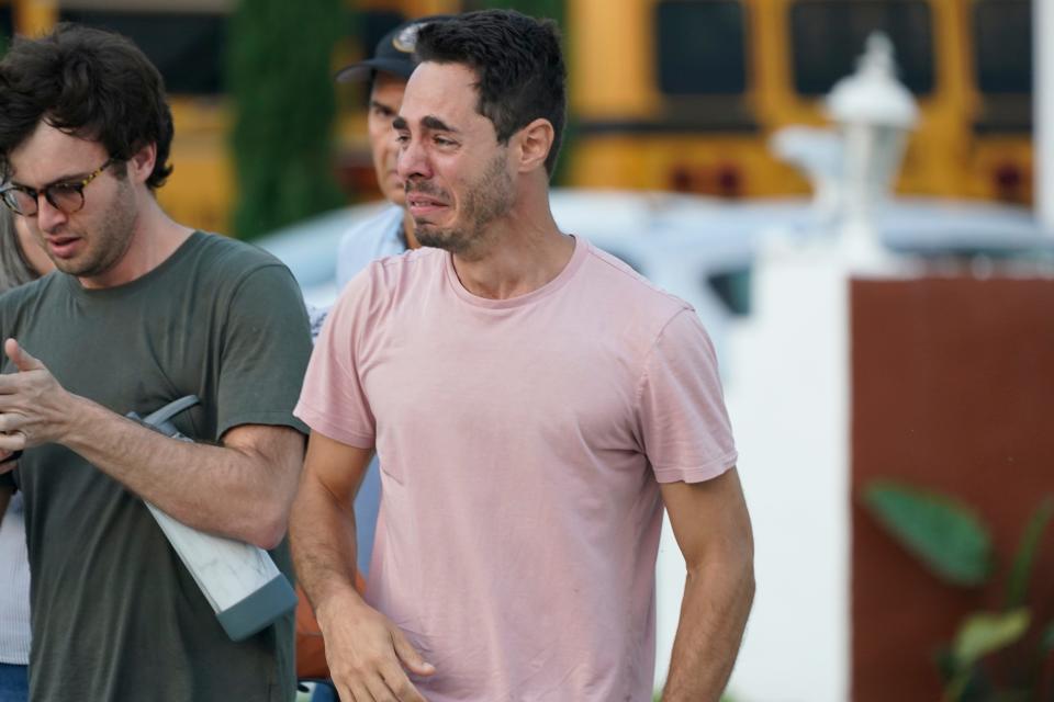 A man reacts as he waits for information after the partial building collapse in Surfside.