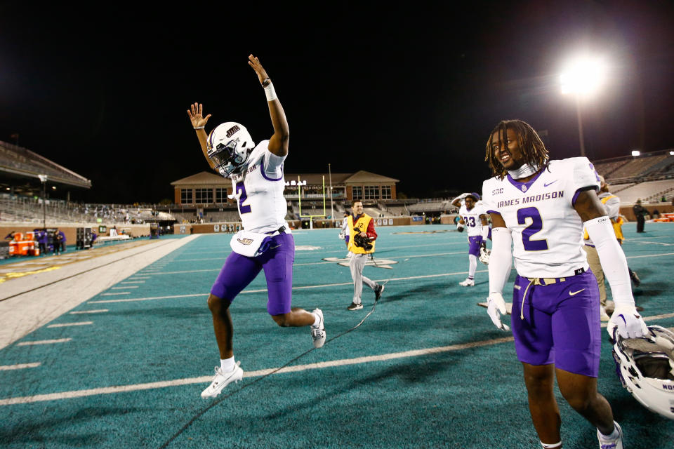 CONWAY, SOUTH CAROLINA - NOVEMBER 25: Jordan McCloud #2 of the James Madison Dukes celebrates with Chauncey Logan #2 of the James Madison Dukes after defeating the Coastal Carolina Chanticleers, 56-14, at Brooks Stadium on November 25, 2023 in Conway, South Carolina. (Photo by Isaiah Vazquez/Getty Images)