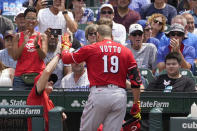 Cincinnati Reds' Joey Votto celebrates his two-run home run off Chicago Cubs starting pitcher Alec Mills outside the dugout during the first inning of a baseball game Thursday, July 29, 2021, in Chicago. Jesse Winker also scored on the play. (AP Photo/Charles Rex Arbogast)