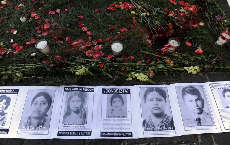 Pictures of people disappeared during civil war are displayed outside court in Guatemala City on January 28, 2013. Former dictator Efrain Rios Montt is accused of orchestrating the massacre of more than 1,750 indigenous Maya people during his time in power