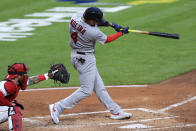 St. Louis Cardinals' Yadier Molina hits an RBI sacrifice fly in the third inning of a baseball game against the Cincinnati Reds in Cincinnati, Monday, Aug. 31, 2020. (AP Photo/Aaron Doster)