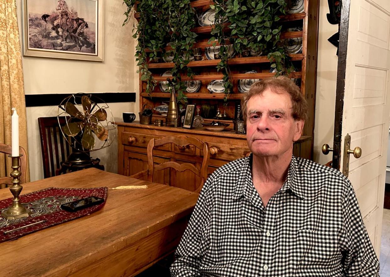 John Cufflin, 76, has owned his West Hillhurst home since 1991 — when he moved permanently to Calgary from London, England. The house is filled with beloved antiques he's collected over the decades. (Karina Zapata/CBC - image credit)