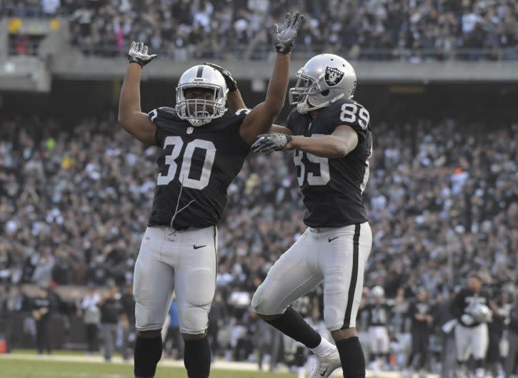 Dec 4, 2016; Oakland, CA, USA; Oakland Raiders wide receiver Amari Cooper (89) and running back Jalen Richard (30) celebrate after a 37-yard touchdown reception by Cooper in the fourth quarter against the Buffalo Bills during a NFL football game at Oakland Coliseum. The Raiders defeated the Bills 38-24. Mandatory Credit: Kirby Lee-USA TODAY Sports