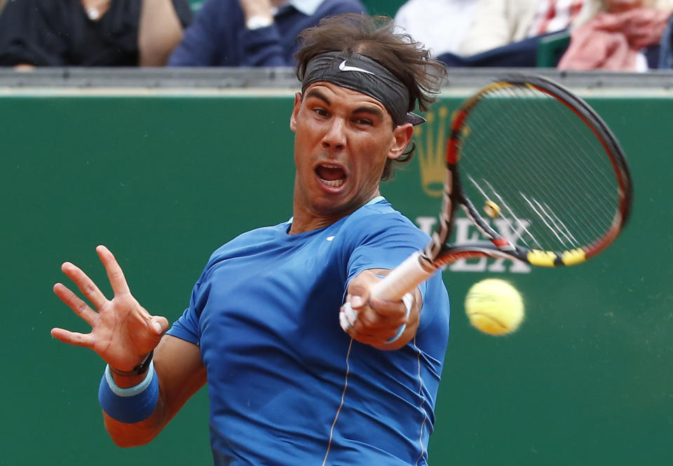 Rafael Nadal of Spain returns the ball to Teymuraz Gabashvili of Russia during their match of the Monte Carlo Tennis Masters tournament in Monaco, Wednesday, April 16, 2014. Nadal won 6-4 6-1. (AP Photo/Michel Euler)