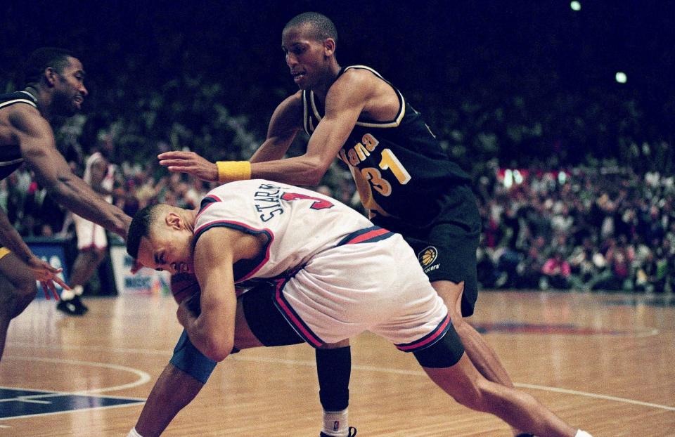 New York Knicks' John Starks, bottom, protects himself from Indiana Pacers' Reggie Miller as Miller flagrantly fouled Starks in the final seconds of Game 7 of the Eastern Conference Finals in New York Sunday, June 5, 1994. The Knicks advanced to the NBA Finals with the Houston Rockets with the 94-90 victory. (AP Photo/Ron Frehm)