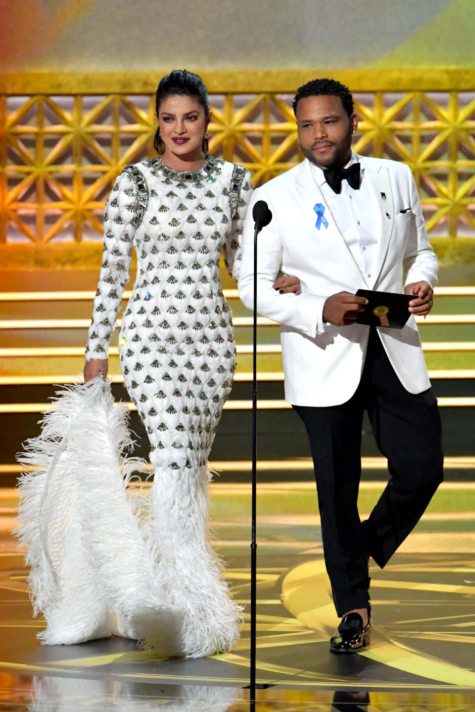 Actors Priyanka Chopra and Anthony Anderson walk onstage during the 69th Annual Primetime Emmy Awards at Microsoft Theater on Sept. 17, 2017 in Los Angeles, California.&nbsp;