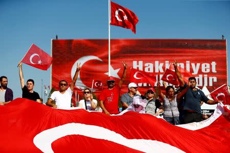 Supporters of various political parties gather in Istanbul's Taksim Square and wave Turkey's national flags before the Republic and Democracy Rally organised by main opposition Republican People's Party (CHP), Turkey, July 24, 2016. REUTERS/Osman Orsal