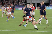 FIEL - In this Oct. 13, 2019, file photo, Japan's Kenki Fukuoka crosses the goal line for his team's third try against Scotland during the Rugby World Cup Pool A match at the International Stadium in Yokohama, Japan. (AP Photo/Christophe Ena, File)