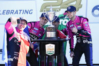 Simon Pagenaud, left, of France, takes a selfie photo with teammates, Oliver Jarvis, of Great Britain, Helio Castroneves, of Brazil and Tom Blomqvist, of Monaco after winning the Rolex 24 hour auto race at Daytona International Speedway, Sunday, Jan. 30, 2022, in Daytona Beach, Fla. (AP Photo/John Raoux)