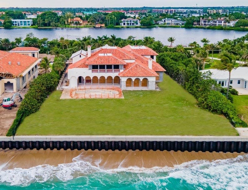 Near Palm Beach, an ocean-to-lake estate at 1140 S. Ocean Blvd. in Manalapan was photographed around the time it entered the market in late 2022 at $59 million, a price that would have included an extensive renovation. The estate just sold with the construction underway for $32.5 million.