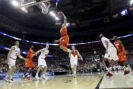 Syracuse guard Brandon Triche (20) elevates toward the basket as Indiana forwards Will Sheehey (0) and Cody Zeller (40) watch during the second half of an East Regional semifinal in the NCAA college basketball tournament, Thursday, March 28, 2013, in Washington. (AP Photo/Pablo Martinez Monsivais)